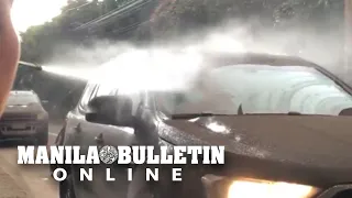 Group of people helped motorists wash ash off their windshields caused by Taal Volcano eruption