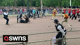 Jubilee parade shows protesters storming onto the mall before being dragged away by police | SWNS