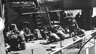 Sailors test fire hose aboard LST in Portland, England,  during World War II. HD Stock Footage