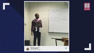 Picture of teacher holding infant for his student during class goes viral
