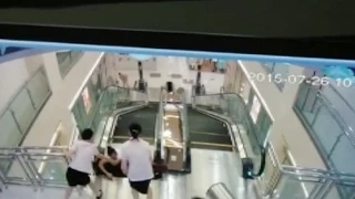 Woman Dies after Falling into Shopping Mall Escalator