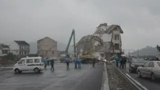 Chinese house in middle of road demolished