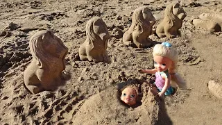 Elsa and Anna toddlers play in the sand