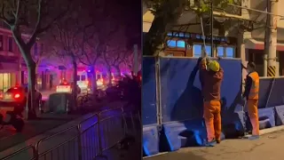 China: Police presence, workers install barricades in Shanghai after protests | AFP