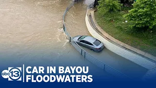 Car ends up in White Oak Bayou floodwaters