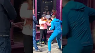 Teenagers harass and throw food at busker