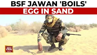 A Border Security Force (BSF) Jawan 'Boils' Egg In Sand Amid The Prevailing Intense Heat In Bikaner