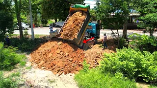 Incredible dump truck unloading dirt and bulldozer pushing spreading dirt building connections road