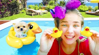 Maggie is swimming with puppy Shanti in the swimming pool! best stories for kids