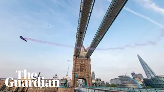 Skydivers fly through London's Tower Bridge