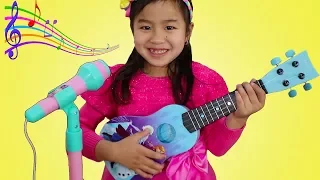 Jannie Plays with Disney Frozen Toy Guitar and Starts a Band