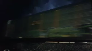 A BNSF auto train flies through a thunderstorm