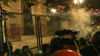 Tear gas fired as protesters try to break down courthouse fence in Portland | AFP