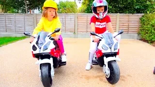 Kids play racers on ride on toy motorbikes