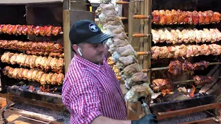 Germany Street Food in Italy. Huge Grills with Pork Legs Skewers, Burgers, Sausages. Sud Tirol