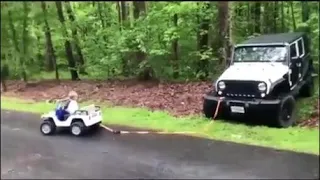 the kid pulls the jeep out of the ditch