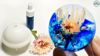 Flower in epoxy resin. Sphere Resin art. Epoxy resin. DIY