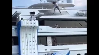 FunAir Climbing Wall and Blob combo with lady jumping higher than the top deck of the yacht