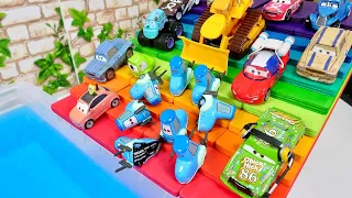 The Cars minicars running down the rainbow's edge are going to fall into the blue water!