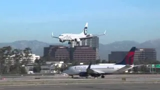 Alaska Airlines Plane Landing at John Wayne Airport with Mountains and Highrise Buildings #flyJWA