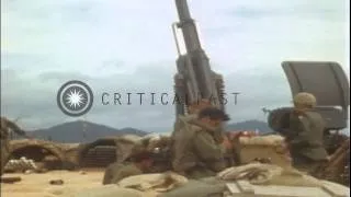 An M114 155 mm howitzer in operation and men help a soldier knocked down at Fire ...HD Stock Footage