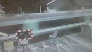 Shocking CCTV: Cyclist narrowly avoids being hit by train at level crossing