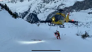 Helicopter mountain rescue freeride skier in Silvretta Austria