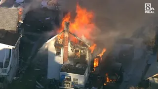 2 officers shot outside home that is then gutted by fire; multiple residents unaccounted for