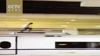 Footage: man electrocuted after climbing on roof of high-speed train