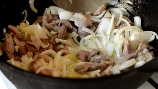 Chicken stomachs with onions in a cauldron