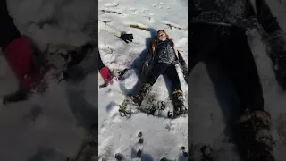 Alle and Olivia making snow angels