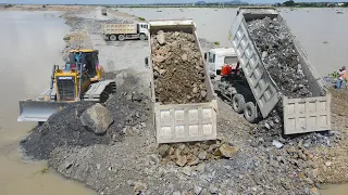 Top Activities Build Road on water with Dump Truck, Bulldozer Operator Moving Stones into Huge Lake