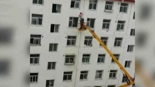 Man saves girl hanging from sixth floor window