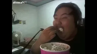 Asian guy eats ice cream and gets brain freeze