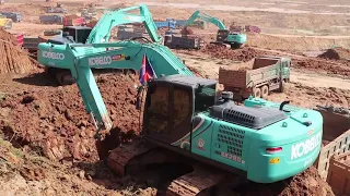 Amazing power digger KOBELCO excavator loading Dirt into dump trucks