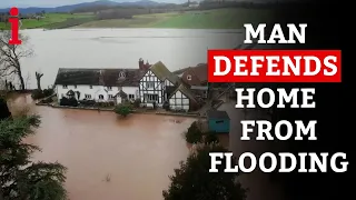 Man DEFENDS Home From Being Engulfed In Flood Waters With Self Made Barriers