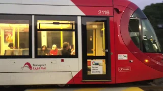 Light rail vehicle departs w/ electrical spark (Sydney Light Rail)