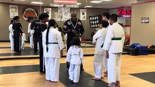 Grandmaster Orange 🍊 demonstrates his bionic arm to the Sidekicks students