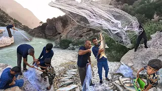 Nomadic men fishing from raging river