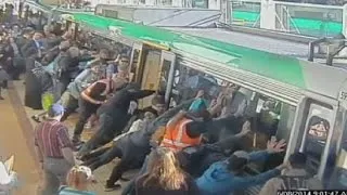 Mind the gap: Commuters push train to save trapped man in Perth