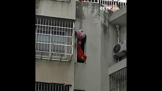 Rescuers save girl trapped outside sixth floor of building| CCTV English