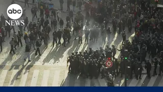 Riot police and protesters clash in Paris