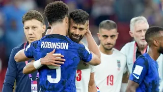 Watch heartwarming moment USA star Antonee Robinson hugs distraught Ramin Rezaeian