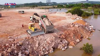 Great Team work Filling up land Full Video processing Dump trucks with Dozer pushing Rock into water