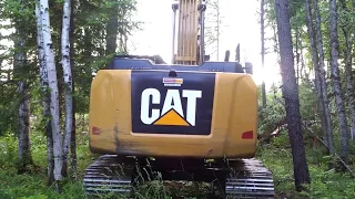 Excavator clearing trees