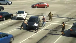 Video: Good Samaritans get out of cars to stop vehicle from drifting into busy intersection | ABC7