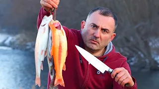 Trout fried on a frying pan.