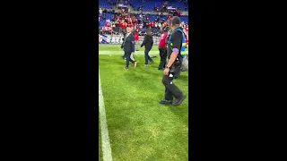 Taylor Swift walks on the field to congratulate Travis Kelce after the Chiefs AFC Championship win