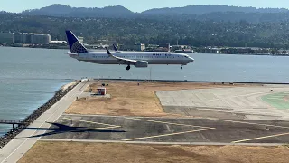 So close! Stunning SFO parallel landing on 28L. Is it a tie at touchdown?