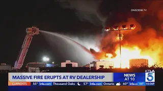 Massive fire erupts at RV dealership